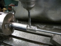 Drilling and reaming the small end bearing hole.
