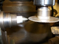Setting up the slitting saw to centre line of the dividing head.
